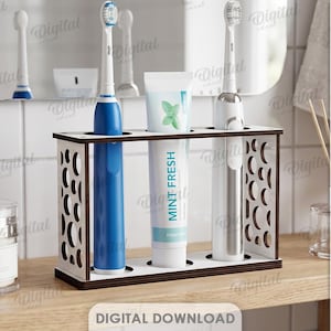 May include: A rectangular white and dark brown wooden toothbrush and toothpaste holder with circular cutouts on the side panels. The stand features three circular openings holding two electric toothbrushes and a tube of Mint Fresh toothpaste. Material width: 3 mm.