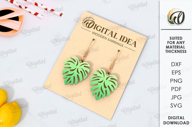 May include: A digital download of a pair of wooden earrings featuring a green monstera leaf design. The earrings are shown on a brown card with the text "Digital Idea Wooden Earrings".
