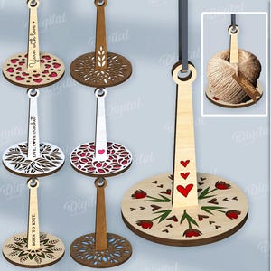 May include: A selection of wooden yarn holders with decorative designs. Some feature cut-out patterns, hearts, or floral motifs. Text includes "Yarn with love", "Live, love, crochet", and "Born to knit". Material width is 3 mm.