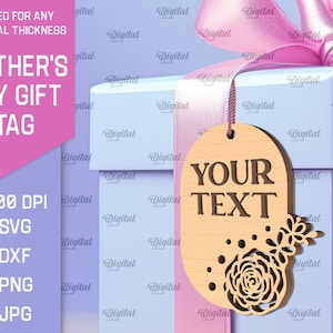 May include: A light blue gift box with a pink ribbon and a wooden tag that says "YOUR TEXT". The tag has a floral design with a rose and leaves. The tag is perfect for a Mother's Day gift.