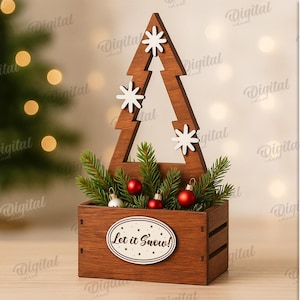May include: A wooden Christmas tree decoration with a rectangular base and a tree-shaped top. The tree has white snowflake accents and holds greenery, red ornaments, and the text "Let it Snow!".