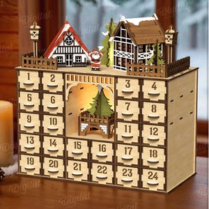 May include: A wooden advent calendar with 24 numbered drawers. The top features miniature houses and a Santa figure. A lit candle and pinecones are in the foreground. The material width is 3 mm.