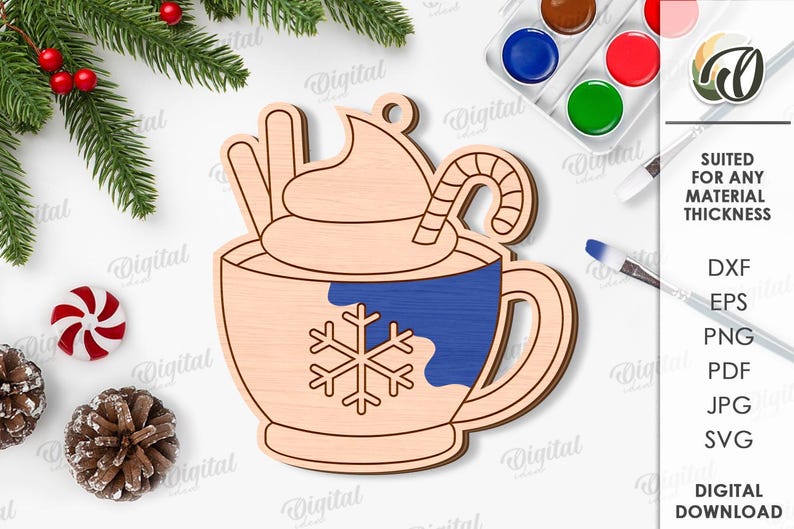 May include: Wooden Christmas ornament in the shape of a hot chocolate mug with whipped cream, a candy cane, and a snowflake design. The mug has a blue section and is surrounded by festive decorations and text that says "SUITED FOR ANY MATERIAL THICKNESS".