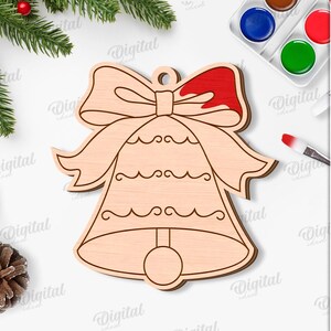 May include: A wooden Christmas bell ornament with a bow, partially painted red. The image includes a paintbrush, watercolor paints, and text that reads "SUITED FOR ANY MATERIAL THICKNESS" and "DIGITAL DOWNLOAD".