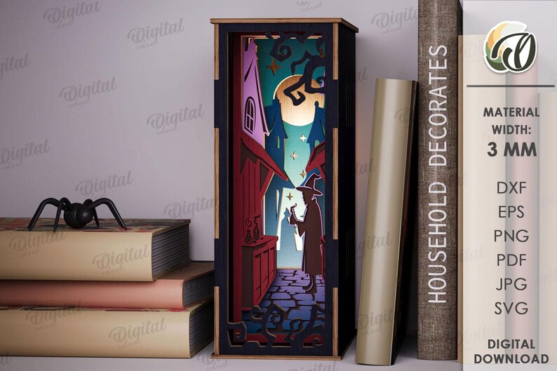 May include: A laser-cut wooden Halloween-themed shadow box depicting a witch in a spooky alleyway. The box is black with a 3 mm width and features a witch, buildings, and a full moon. A black spider sits on a stack of books. The text "HOUSEHOLD DECORATES" is visible.