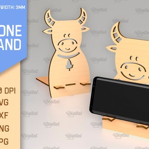 May include: A wooden phone stand with a bull design. The stand is 3 mm thick and is available in SVG, DXF, PNG, and JPG formats. The stand is 300 DPI.