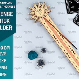 May include: A wooden incense stick holder with a sun design. The holder is light brown with a peach colored groove for the incense stick. The sun has a face and rays. The holder is on a white background with small blue and gray stones.