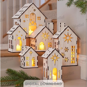 May include: A collection of ten light-colored wooden house-shaped lanterns with cut-out designs including stars, snowflakes, and hearts. Each structure features an internal light source, and the set includes digital files in 3 mm width.