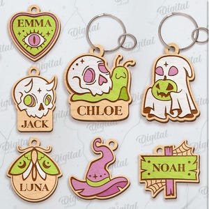 May include: A collection of ten Halloween-themed wooden keychains with various designs, including ghosts, skulls, pumpkins, and witch hats. Each keychain features a unique design with names like Mia, Emma, Jack, Chloe, Lily, Luna, and Noah. The keychains are suitable for any material thickness.