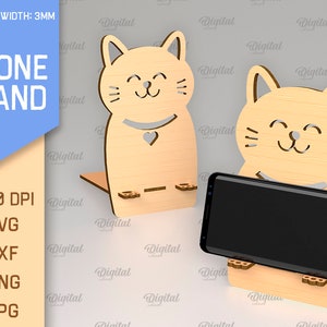 May include: A wooden phone stand shaped like a cat with a smiling face. The stand is 3mm thick and is designed to hold a smartphone upright. The stand is made of wood and has a natural finish.
