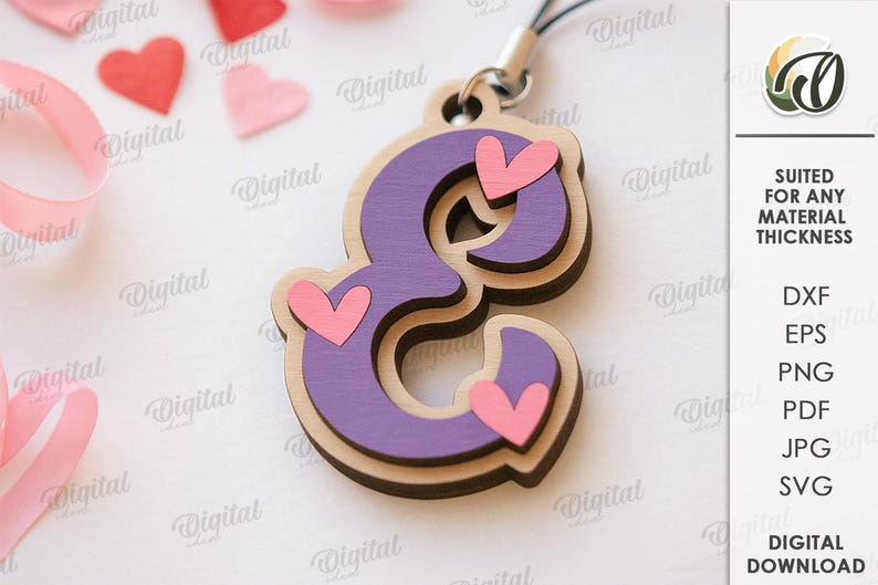 May include: A layered wooden charm in the shape of the letter "E", painted purple with pink heart accents. The charm is attached to a black cord. The background includes pink and red heart shapes and a pink ribbon.