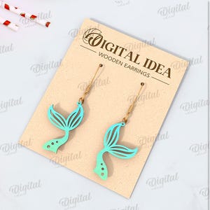 May include: A digital download of mermaid tail earrings. The earrings are made of wood and are available in a variety of colors. The design is suitable for any material thickness. The download includes the following file formats: DXF, EPS, PNG, PDF, JPG, and SVG.