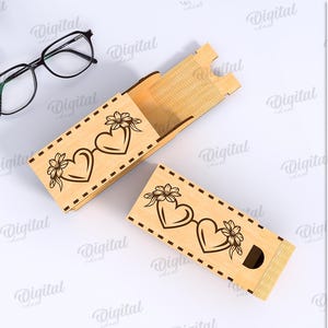 May include: Two open wooden boxes with a sliding lid, featuring a laser-cut design of two connected hearts and flowers. The boxes are made of light-colored wood. The material width is 3 mm.
