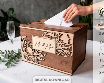 May include: A wooden wedding card box with laser-cut floral designs and a "Mr. & Mrs." sign. The box is brown with a light wood accent. A hand is placing a card into the slot. A champagne glass and greenery are in the background.