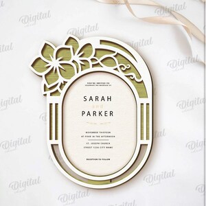 May include: A laser-cut wedding invitation with a floral design. The invitation features the names "SARAH and PARKER" and event details. The design includes a decorative frame and the text "SUITED FOR ANY MATERIAL THICKNESS".