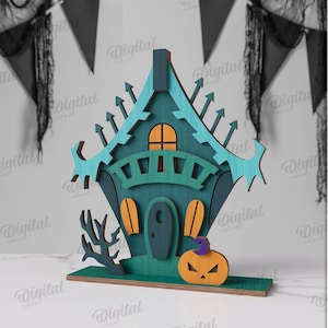 May include: A teal and orange Halloween wooden house decoration with a pumpkin and spooky tree. The house has a unique design with a 3 mm width. The background includes black pennant flags.