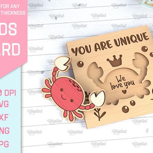 May include: A wooden card with a crab design and the text "You are unique. We love you." The card is light brown with a red crab and white accents.