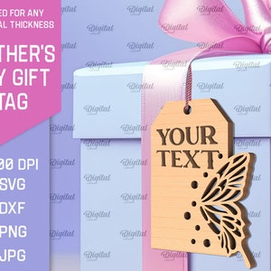 May include: A light blue gift box with a pink ribbon and a wooden gift tag with the text "YOUR TEXT" and a butterfly design. The tag is attached to the box with a string.