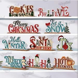 Puede incluir: Una colección de 10 letreros de madera con temática navideña, con frases como "Cookies for Santa" y "Merry Christmas". Cada letrero es multicolor y se asienta sobre una base de madera. Ancho del material: 3 mm.