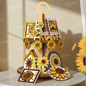 May include: A multi-tiered wooden sunflower-themed display with various cut-out designs. The display includes sunflowers, the words "love you", and "home". The design is suitable for any material thickness. The image also includes the text "10 Designs" and "Digital Download".