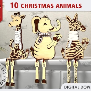 Könnte beinhalten: Zehn Weihnachtstier-Ausschnitte mit einer Materialstärke von 3 mm. Die Tiere sind eine Giraffe, ein Elefant und ein Zebra, alle mit Schals und Bechern. Die Tiere sitzen auf einer weißen Oberfläche mit braunem Hintergrund.