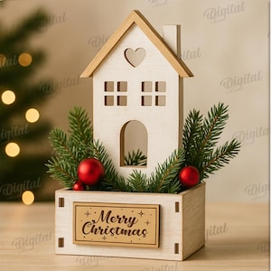 May include: A wooden Christmas decoration in the shape of a house with a heart-shaped cutout. The house is filled with evergreen branches and red ornaments. The base has a sign that reads "Merry Christmas".