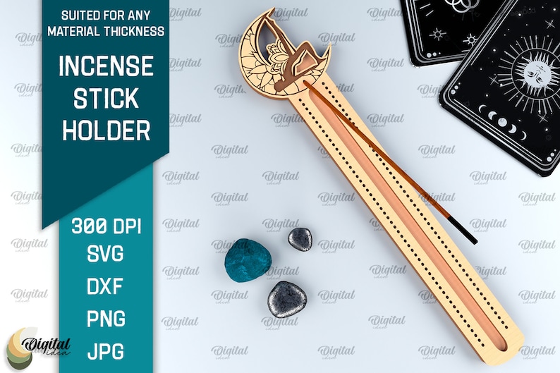 May include: A wooden incense stick holder shaped like a crescent moon with a mandala design. The holder has a slot for the incense stick and a groove for the ash to fall into. The holder is made of wood and has a natural finish.