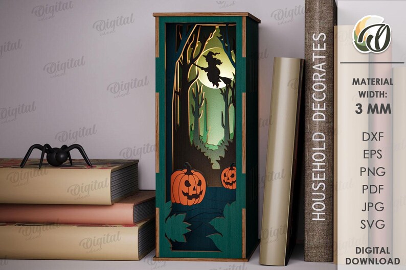May include: A green and brown Halloween-themed decorative lantern with a witch flying in front of a full moon. The lantern features a forest scene with pumpkins and trees. A black spider sits on a stack of books. The text "HOUSEHOLD DECORATES" is visible.