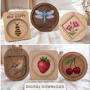 Puede incluir: Una colección de diez diseños de madera con bordados de punto de cruz. Los diseños incluyen una rosa, una abeja, una libélula, flores, lavanda, un pájaro, una fresa y cerezas. El texto "FOCUS", "Don't worry BEE HAPPY" y "ENJOY EVERY MOMENT" son visibles.