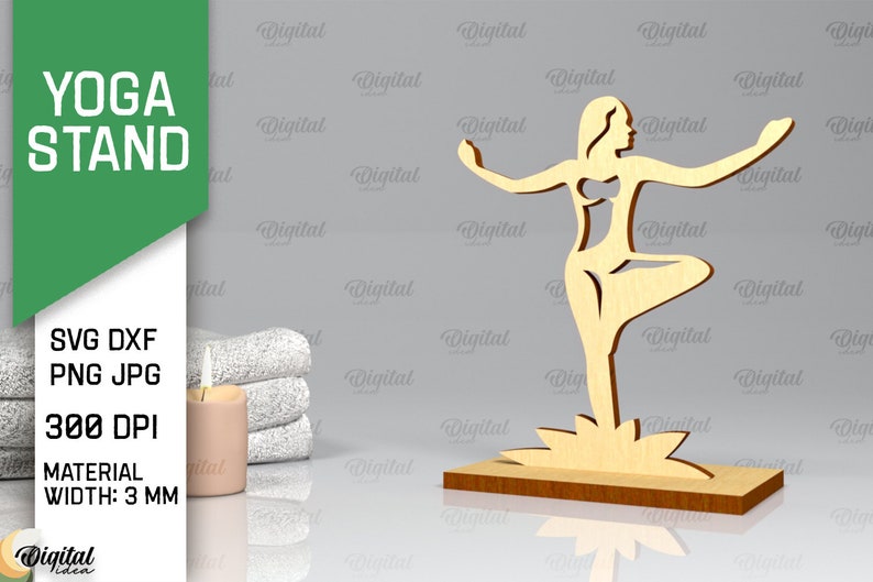Peut inclure: Un support de yoga en bois avec une d&eacute;coupe d'une femme en position de yoga. Le support a une &eacute;paisseur de 3 mm et est con&ccedil;u pour &ecirc;tre utilis&eacute; avec une image de 300 DPI. Le support est sur une surface grise avec une serviette blanche et une bougie.