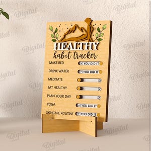 May include: Wooden "Healthy Habit Tracker" with a mountain and yoga figure design. The tracker includes sections for daily habits like drinking water and yoga, with check boxes to mark completion. The material width is 3 mm.
