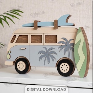 May include: A layered wooden camper van cutout featuring a light blue and beige finish, palm tree silhouettes, a roof-mounted surfboard, and a vertical surfboard attached to the side. Text includes RECOMMENDED MATERIAL: FROM 6MM, DXF, EPS, PNG, PDF, JPG, SVG.