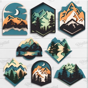 Op de afbeelding: Een verzameling van 10 gelaagde ontwerpen met bergen en bossen in verschillende vormen. De ontwerpen tonen bomen, bergen en een maan, met de tekst "10 DESIGNS", "SUITED FOR ANY MATERIAL THICKNESS" en "DIGITAL DOWNLOAD".