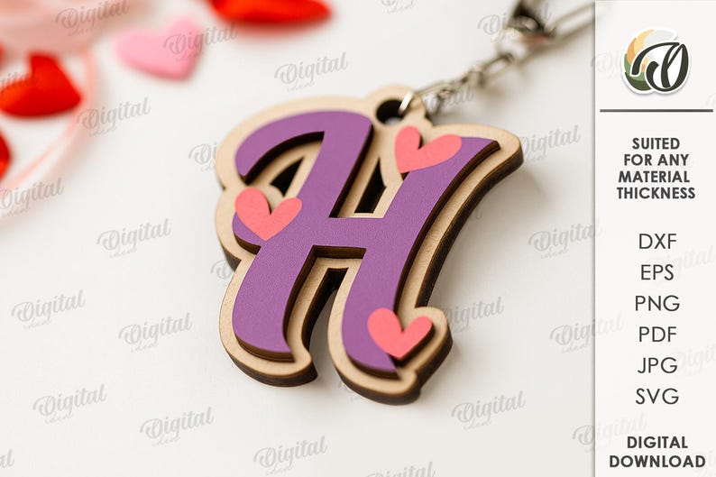 May include: A wooden keychain featuring the letter "H" in purple with pink hearts. The keychain has a layered design with a light brown border. The design is attached to a silver chain. The image also includes the text "SUITED FOR ANY MATERIAL THICKNESS".