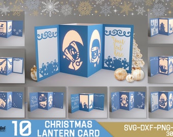 Könnte beinhalten: Zehn verschiedene Designs für Weihnachtslaternenkarten. Jede Karte ist aus blauem Karton und zeigt eine andere Weihnachtsszene, darunter einen Schneemann, den Weihnachtsmann und einen Weihnachtsbaum. Die Karten sind so konzipiert, dass sie ausgeschnitten und zu einer Laternenform zusammengesetzt werden können.