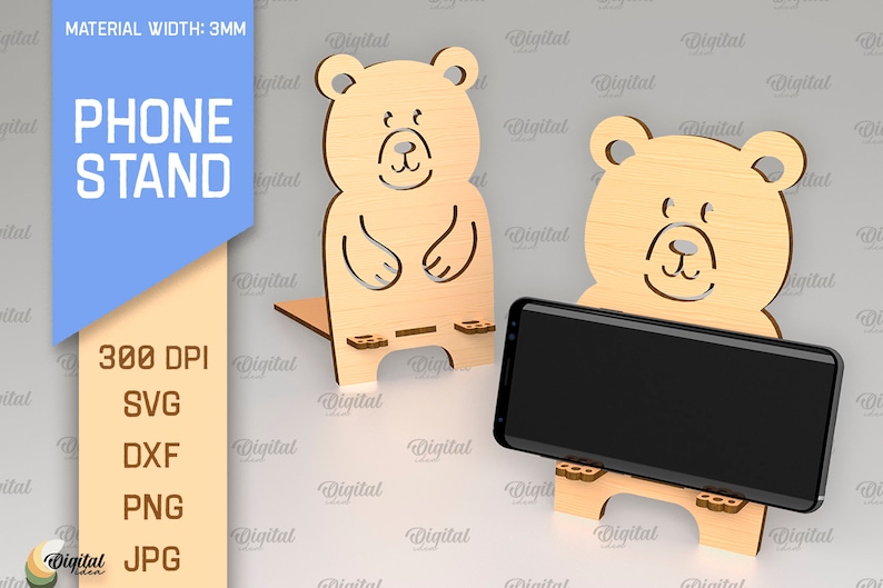 May include: A phone stand made of wood with a bear design. The stand is 3mm thick and is available in SVG, DXF, PNG, and JPG formats. The stand is designed to hold a phone upright.
