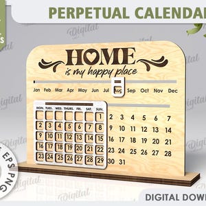 May include: A wooden perpetual calendar featuring the words "Home is my happy place" and a heart design. The calendar has a grid for each month of the year and a separate grid for the days of the week.