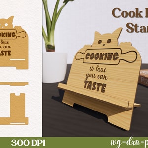 May include: A wooden cookbook stand with a cat design and the text "Cooking is love you can taste". The stand is made of light brown wood and has a cutout of a rolling pin. The stand is 300 DPI and is available in SVG, DXF, PNG, and JPG formats.