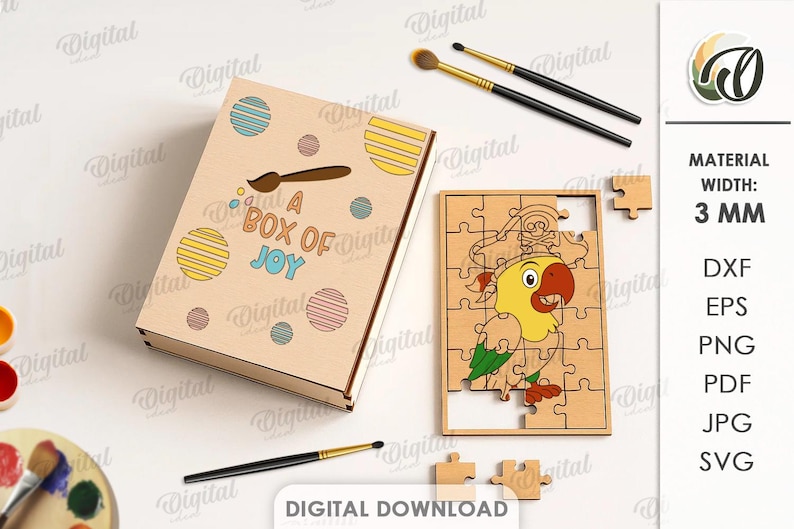 May include: A wooden box and jigsaw puzzle set featuring a parrot design. The box reads "A BOX OF JOY" and has colourful circles. The puzzle is partially assembled. Paintbrushes and a palette are also visible.
