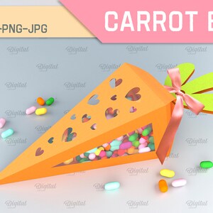 Pode incluir: Uma caixa laranja em forma de cenoura com um design recortado de cora&ccedil;&otilde;es. A caixa est&aacute; cheia de doces coloridos e tem um topo verde com folhas e uma fita rosa.