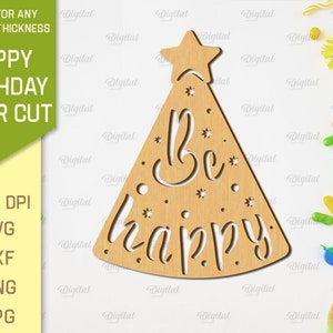 May include: A laser cut wooden party hat with a star on top and the words "Be happy" inside. The hat is on a white background with confetti and party supplies.