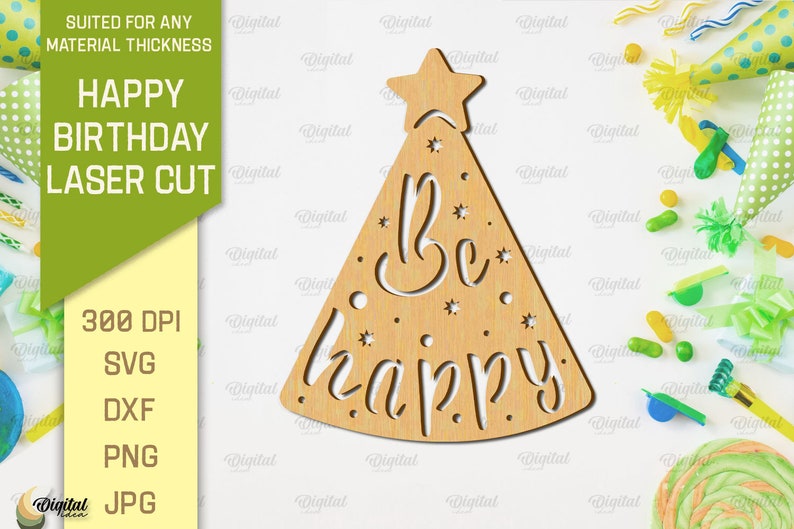 May include: A laser cut wooden party hat with a star on top and the words "Be happy" inside. The hat is on a white background with confetti and party supplies.