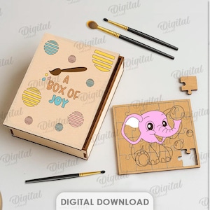 May include: A wooden box with the text "A BOX OF JOY" and colourful dot designs. A wooden puzzle with a pink elephant design is next to the box. Paintbrushes and paint supplies are also in the image.