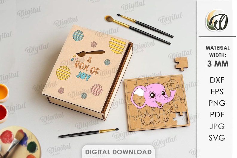May include: A wooden box with the text "A BOX OF JOY" and colourful dot designs. A wooden puzzle with a pink elephant design is next to the box. Paintbrushes and paint supplies are also in the image.