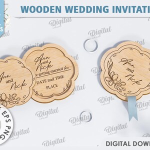 May include: Two wooden wedding invitations with a floral design and the text "Ann and Nick" and "We're getting married".