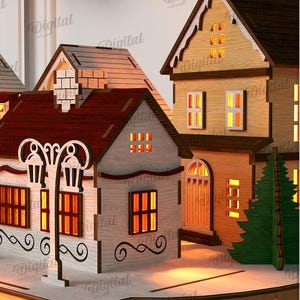 May include: A laser-cut wooden Christmas village scene with illuminated windows and decorative details. The houses have red, brown, and white exteriors, with a street lamp and Christmas trees. The material width is 3 mm.