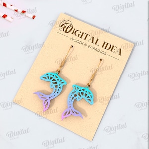 May include: A digital download of a pair of wooden earrings featuring a blue and green gradient dolphin design. The earrings are suitable for any material thickness. The file formats included are DXF, EPS, PNG, PDF, JPG, and SVG.