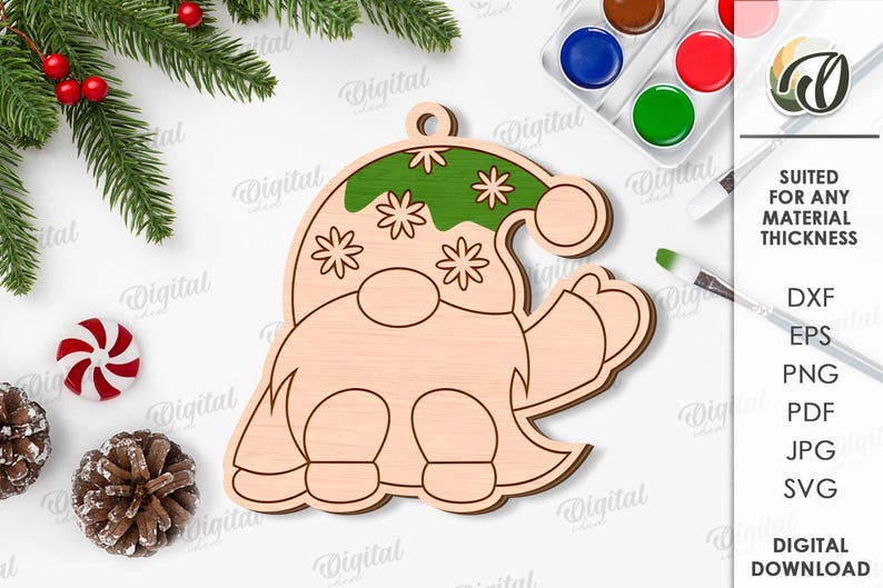 May include: A wooden gnome-shaped Christmas ornament with a green hat decorated with white stars. The ornament is unfinished and ready for painting. The image also includes paint, brushes, and text that says "SUITED FOR ANY MATERIAL THICKNESS".