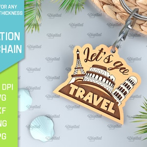 May include: Wooden keychain with a brown background and the text "Let's go travel" in white. The keychain features a silhouette of the Eiffel Tower, the Colosseum, and the Leaning Tower of Pisa.