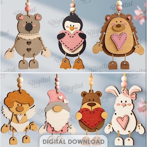 May include: Wooden animal ornaments in various designs, including a giraffe, koala, penguin, hedgehog, cat, dog, angel, gnome, bear, and rabbit. Each ornament holds a heart and has dangling legs. The image also includes the text "10 DESIGNS" and "DIGITAL DOWNLOAD".